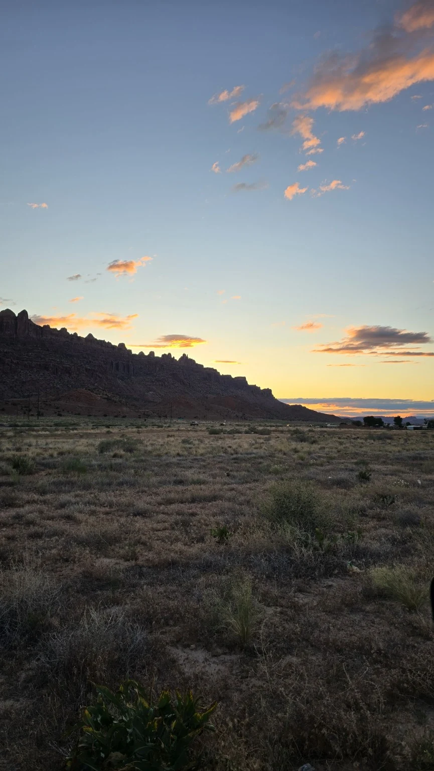 Warm sunset clouds above a desert ridge