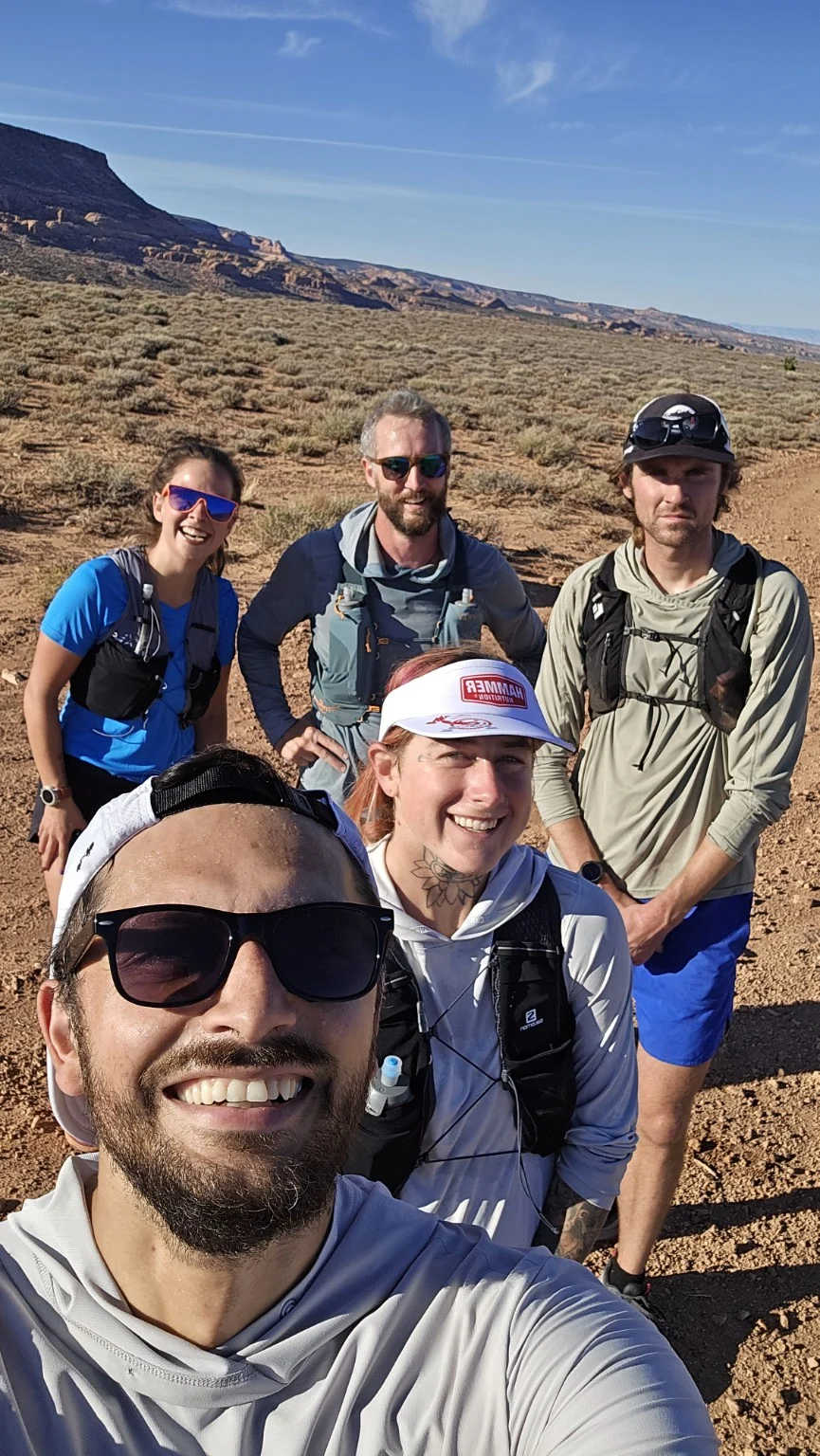 A small group of runners taking a trail selfie